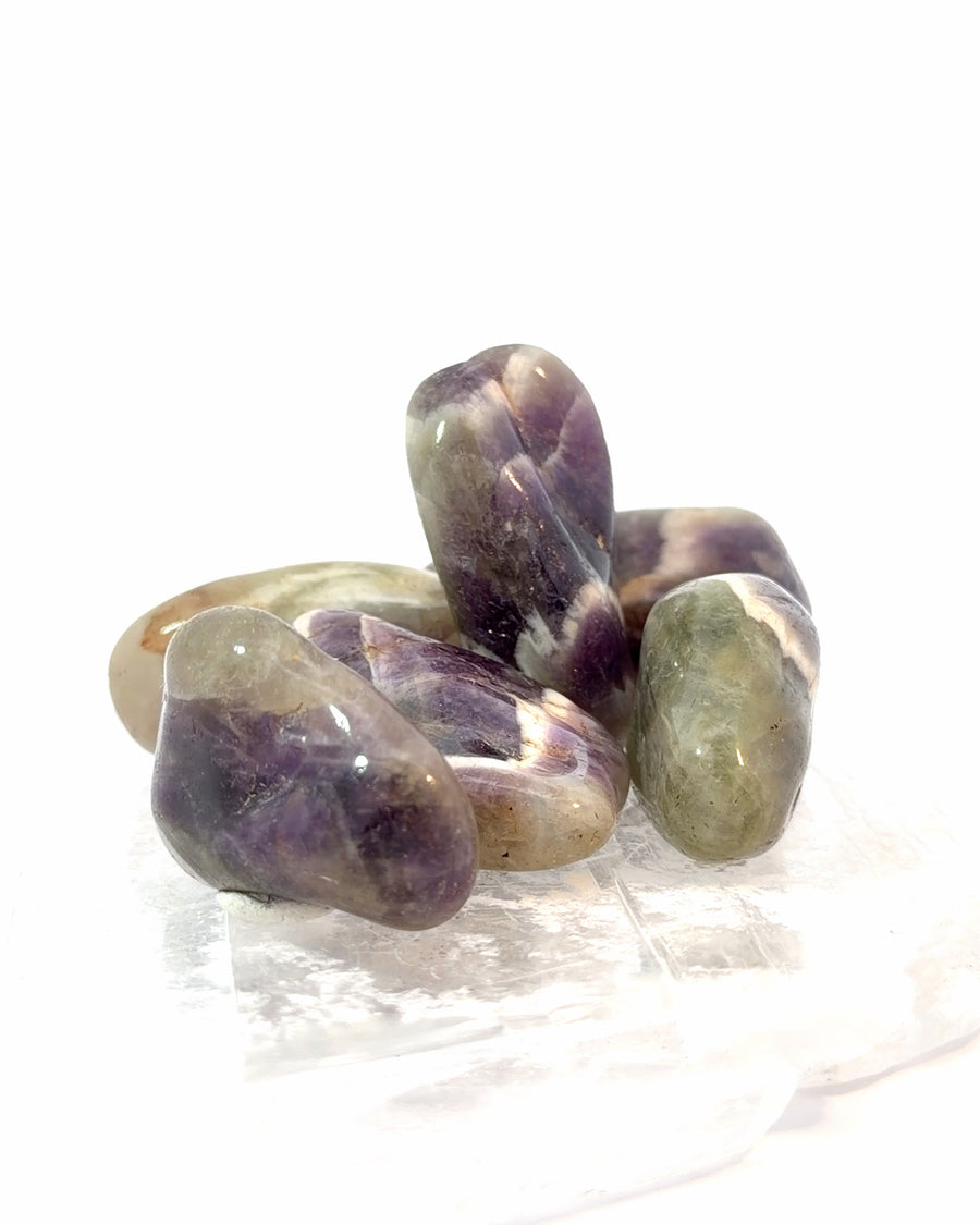 Set of 4 natural Chevron Amethyst tumbled stones with purple and white banded quartz patterns