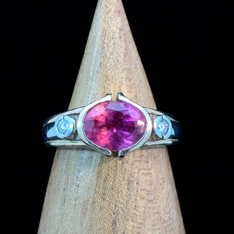 14K two-tone gold ring featuring a natural oval pink tourmaline with diamond accents in a split bezel setting. Size 7 statement ring.