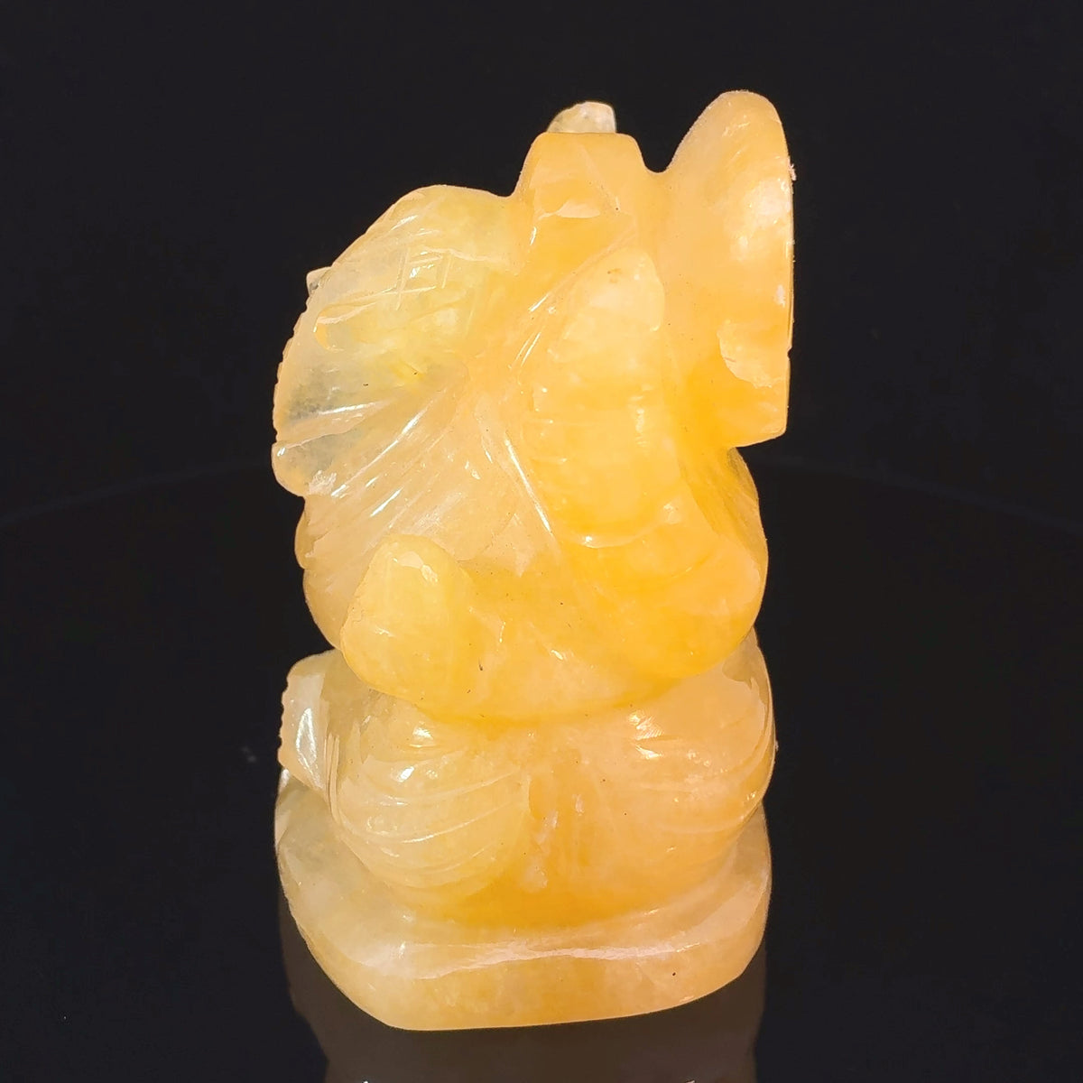 Hand-carved Yellow Calcite Ganesha crystal statue weighing 203 grams and measuring 66 x 52 x 40 mm