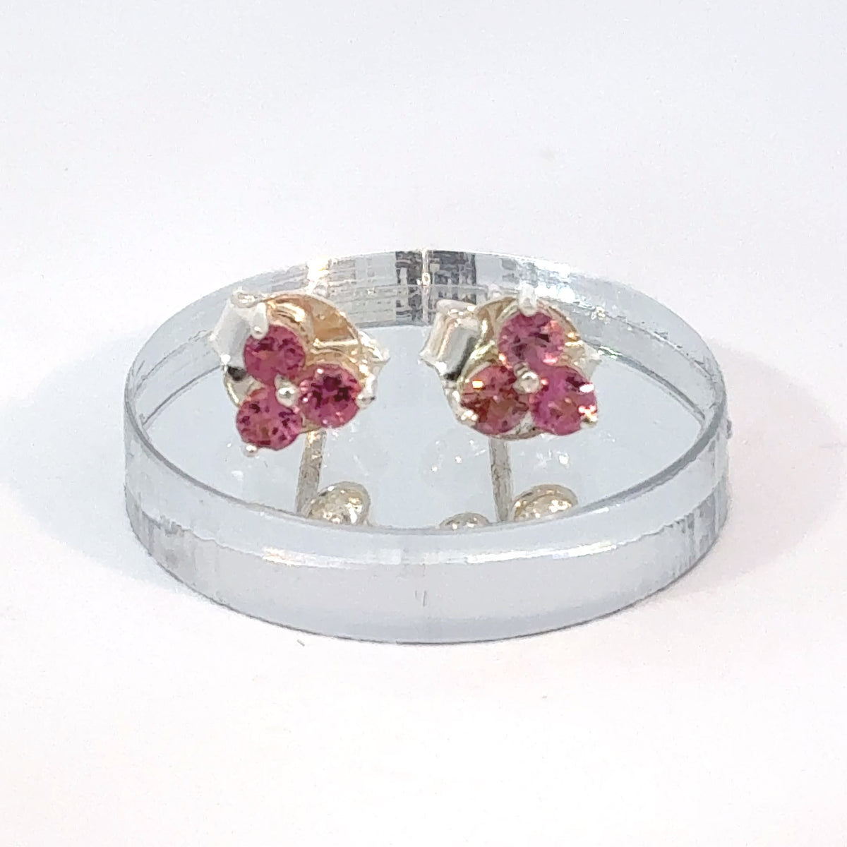 Sterling silver stud earrings with three round Pink Tourmaline gemstones set in each earring