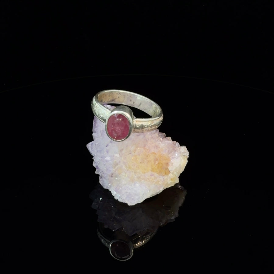 Natural faceted pink-red ruby solitaire ring in sterling silver with an engraved floral band, bezel setting, size 8.5.