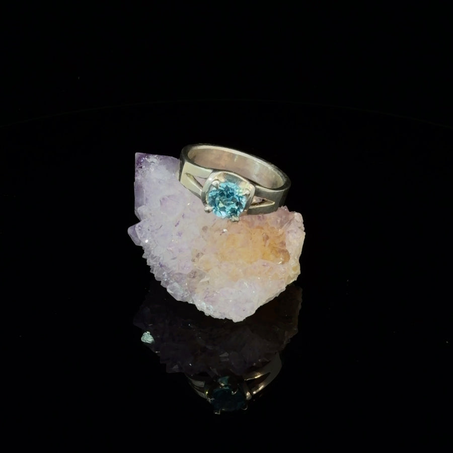 Sterling silver split shank ring featuring a round faceted natural Blue Topaz solitaire in a prong setting, ring size 6.5.