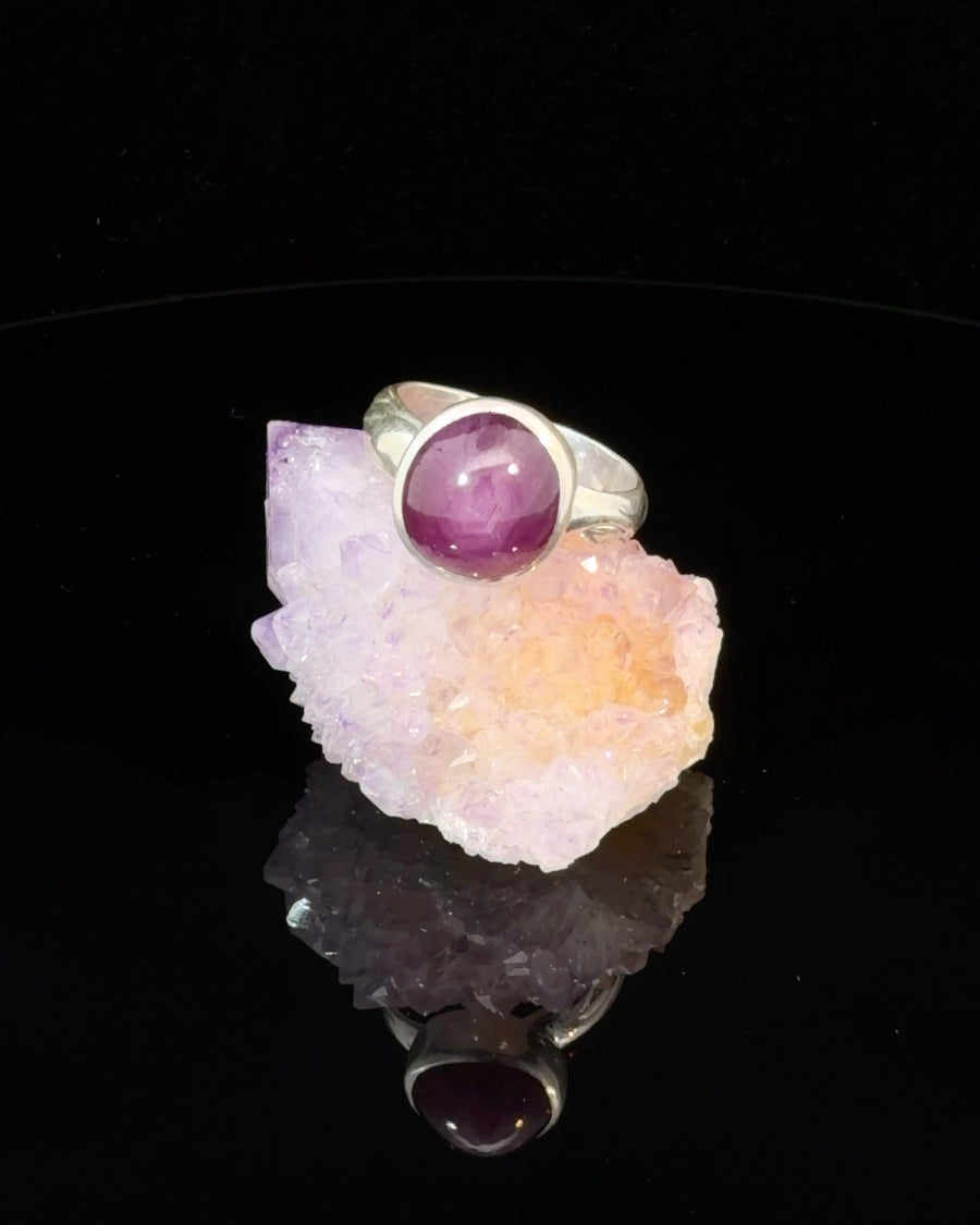 Natural Cat's Eye Ruby cabochon solitaire ring in sterling silver with textured band, bezel set purplish-red gemstone, size 6 handcrafted jewelry.