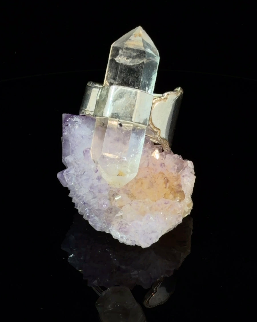 Handcrafted adjustable ring featuring a natural double terminated quartz crystal mounted on an antique silver spoon shank with vintage-inspired styling.
