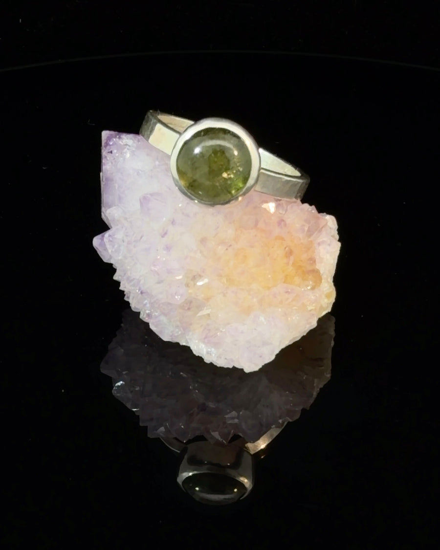 Handcrafted sterling silver bezel solitaire ring featuring a natural round green tourmaline gemstone, minimalist design, size 9.5.