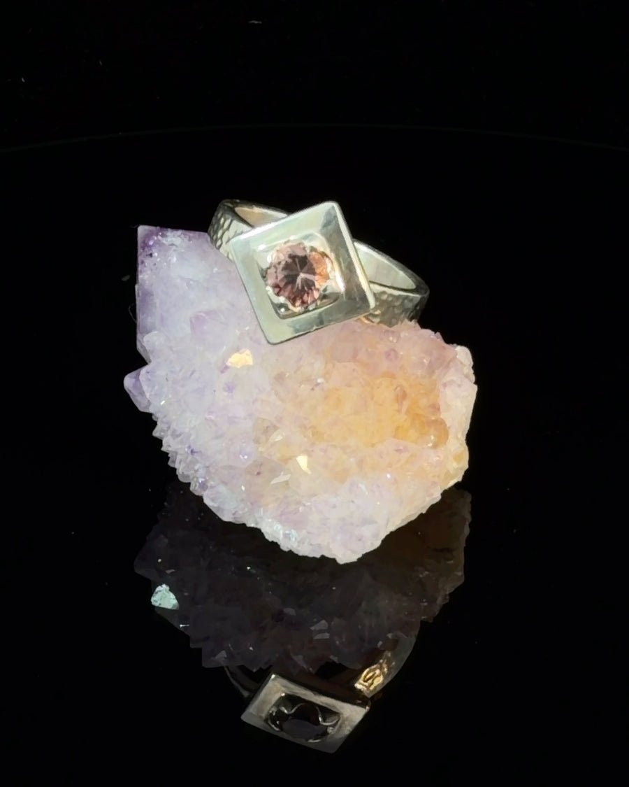 Round pink tourmaline sterling silver solitaire ring with geometric square bezel setting and hammered textured band, size 6.5.
