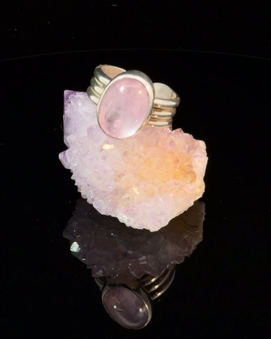 Elegant natural Kunzite cabochon ring in sterling silver featuring a modern bezel setting and adjustable size 5.5–6.5 band.