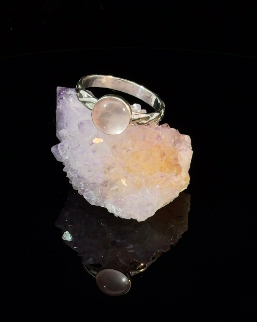 Natural Rose Quartz cabochon solitaire ring in sterling silver with a smooth bezel setting and twisted band, Size 7.
