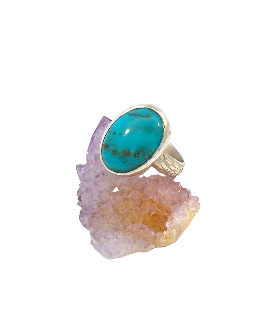 a handcrafted sterling silver Turquoise ring featuring a genuine oval cabochon with natural matrix