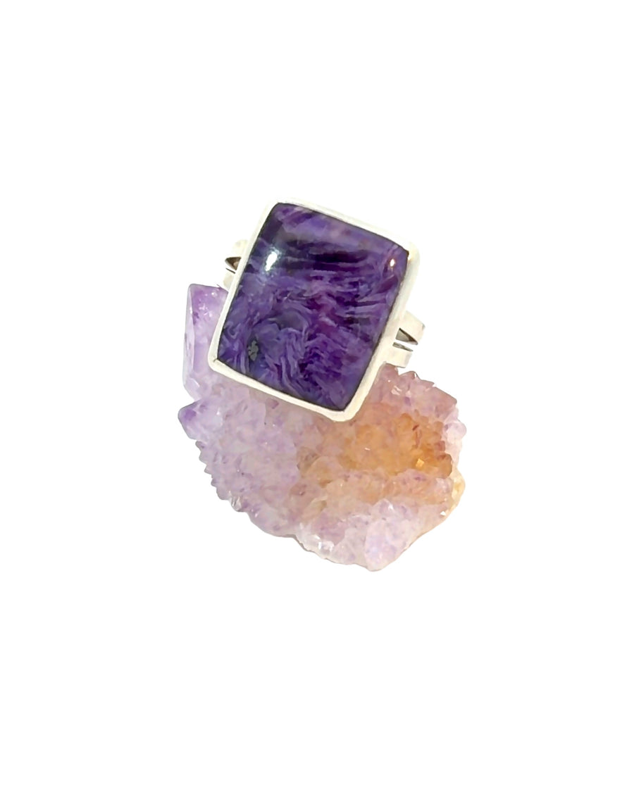 Handcrafted sterling silver statement ring featuring a rectangular bezel-set natural Charoite cabochon with vivid purple swirling patterns, Size 10.