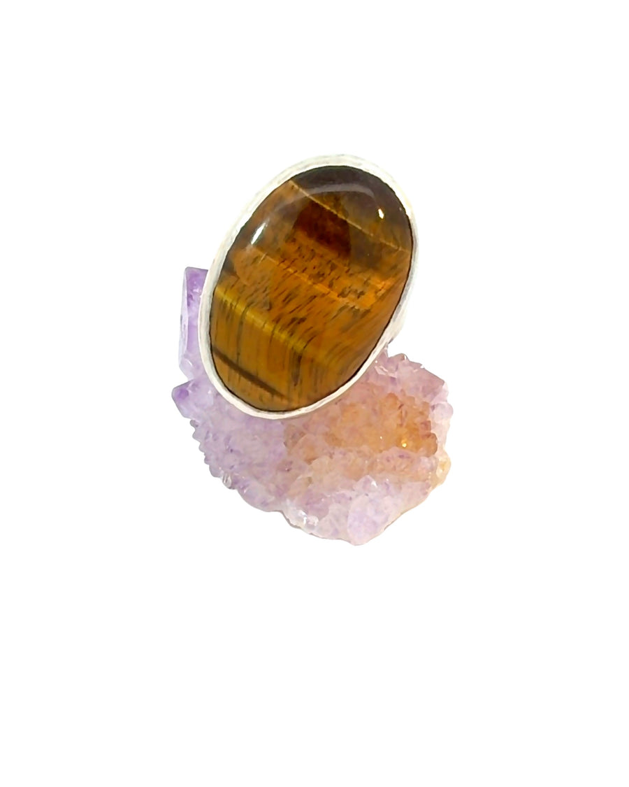 Large oval natural Tiger Eye cabochon bezel set in a handcrafted sterling silver statement ring, Size 9, featuring golden-brown chatoyant bands.