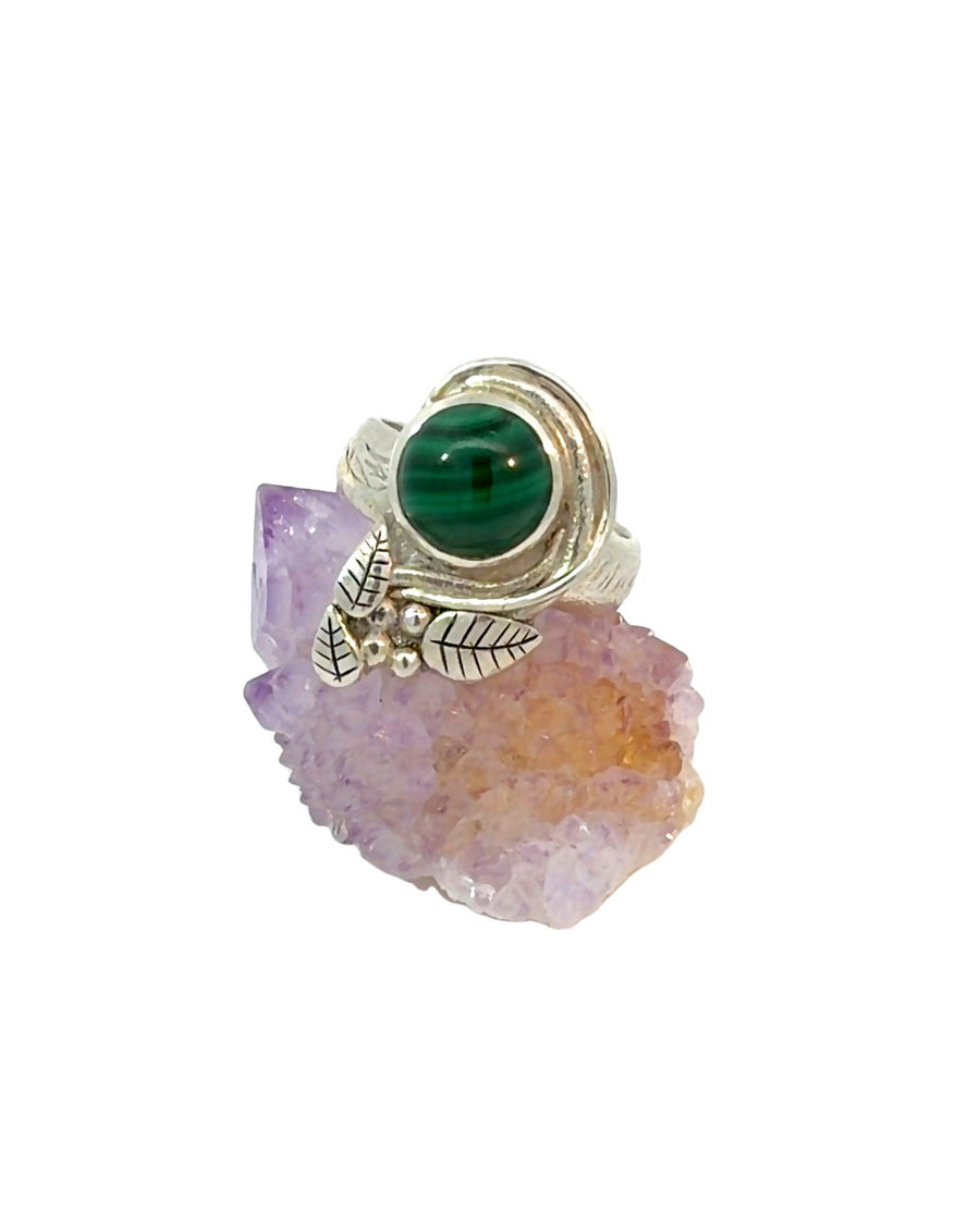Handcrafted sterling silver botanical Malachite ring featuring a round natural green banded Malachite cabochon with detailed leaf accents, silver bead embellishments, textured band, Size 7.5.