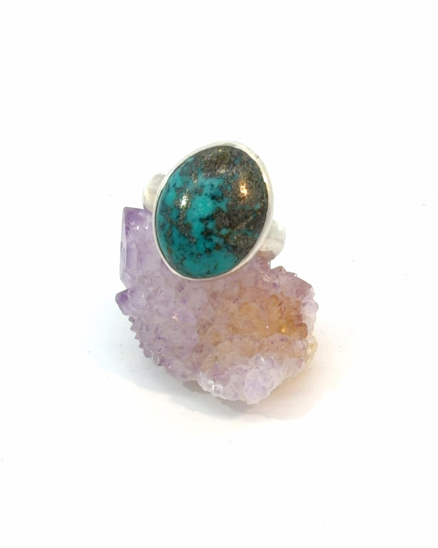 Natural Persian Turquoise cabochon ring in sterling silver featuring a smooth bezel setting and vibrant blue gemstone with a distinctive dark natural matrix, size 9.