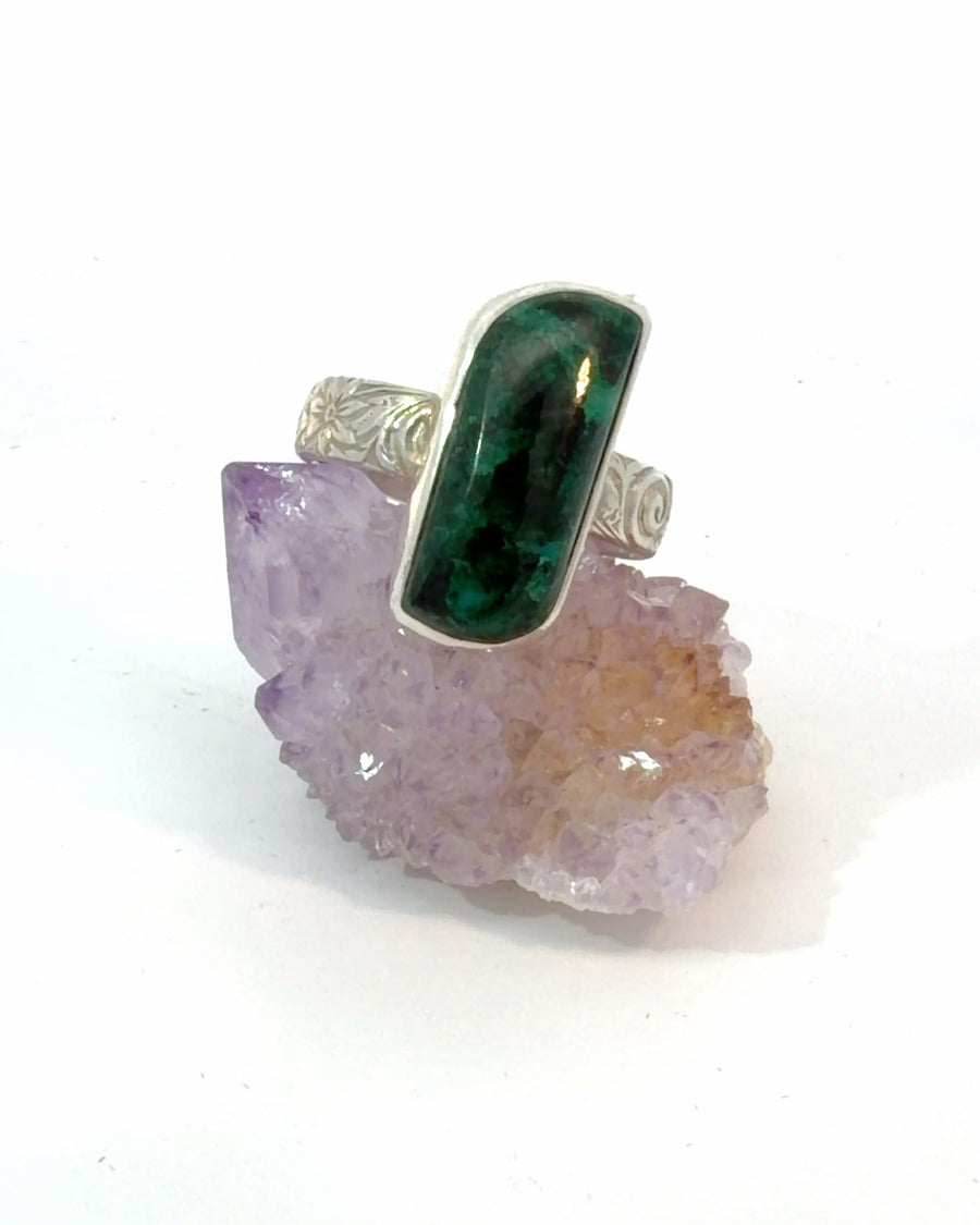 Handcrafted sterling silver Chrysocolla ring featuring an elongated natural deep green and blue bezel-set gemstone with floral engraved textured band, Size 8.