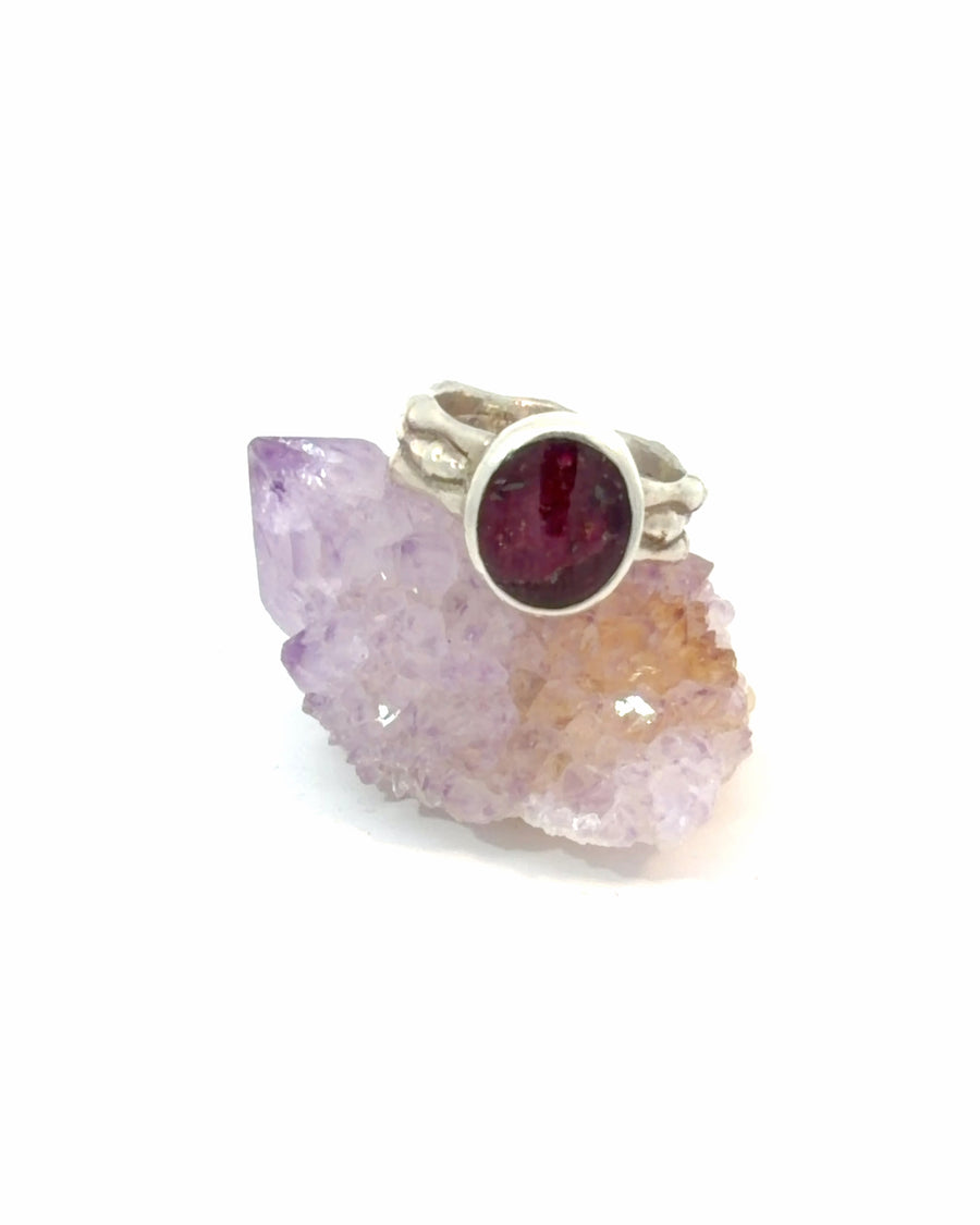 a handcrafted sterling silver ruby ring featuring a natural bezel-set oval ruby on an organic bamboo-inspired band