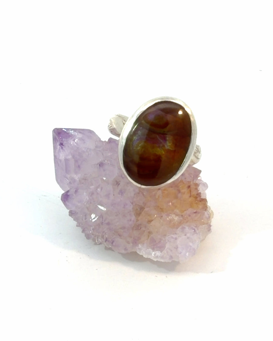 Natural Fire Agate solitaire ring in sterling silver featuring a bezel-set oval gemstone. Size 6