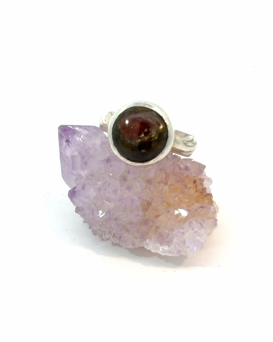 Handmade sterling silver ring featuring a natural green and red Water Tourmaline cabochon in a polished bezel setting with a textured silver band, size 7.5.