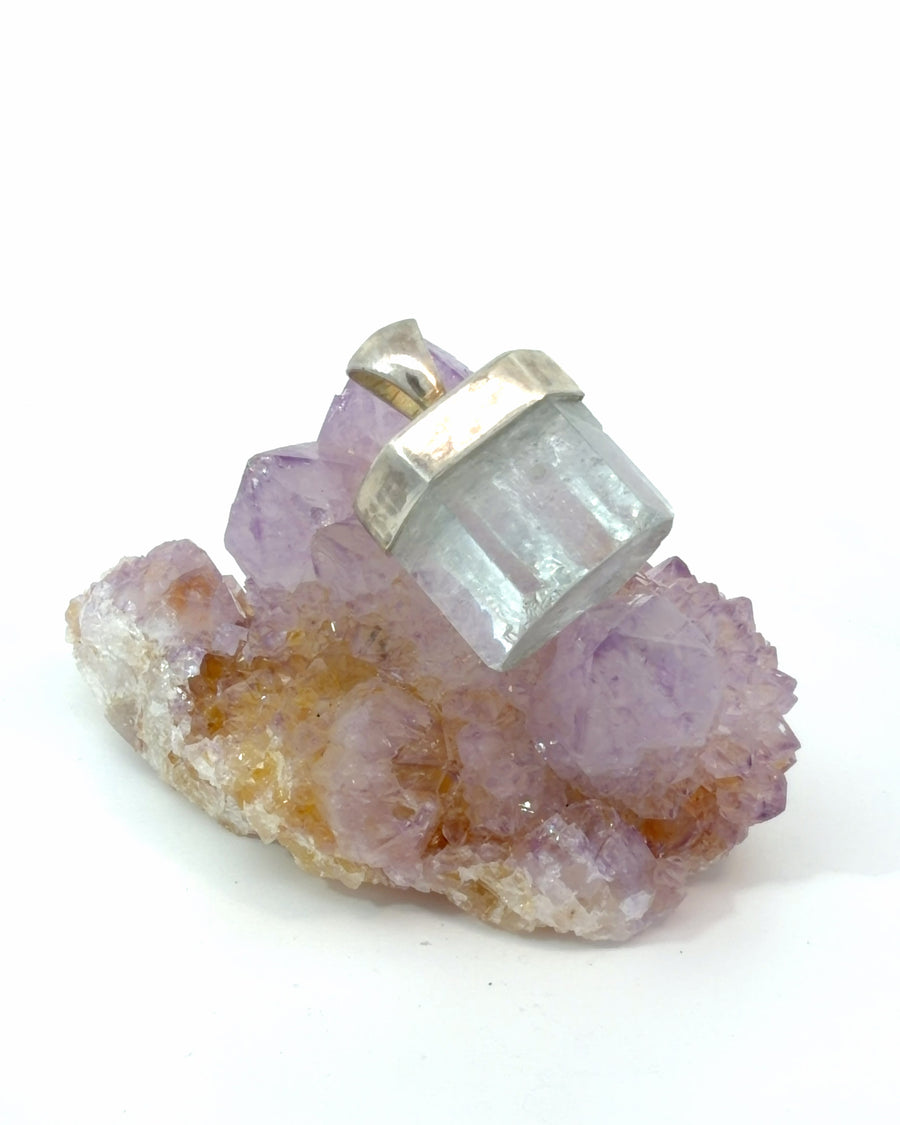 Natural raw aquamarine crystal pendant in sterling silver cap setting featuring a pale blue gemstone with natural crystal formation.