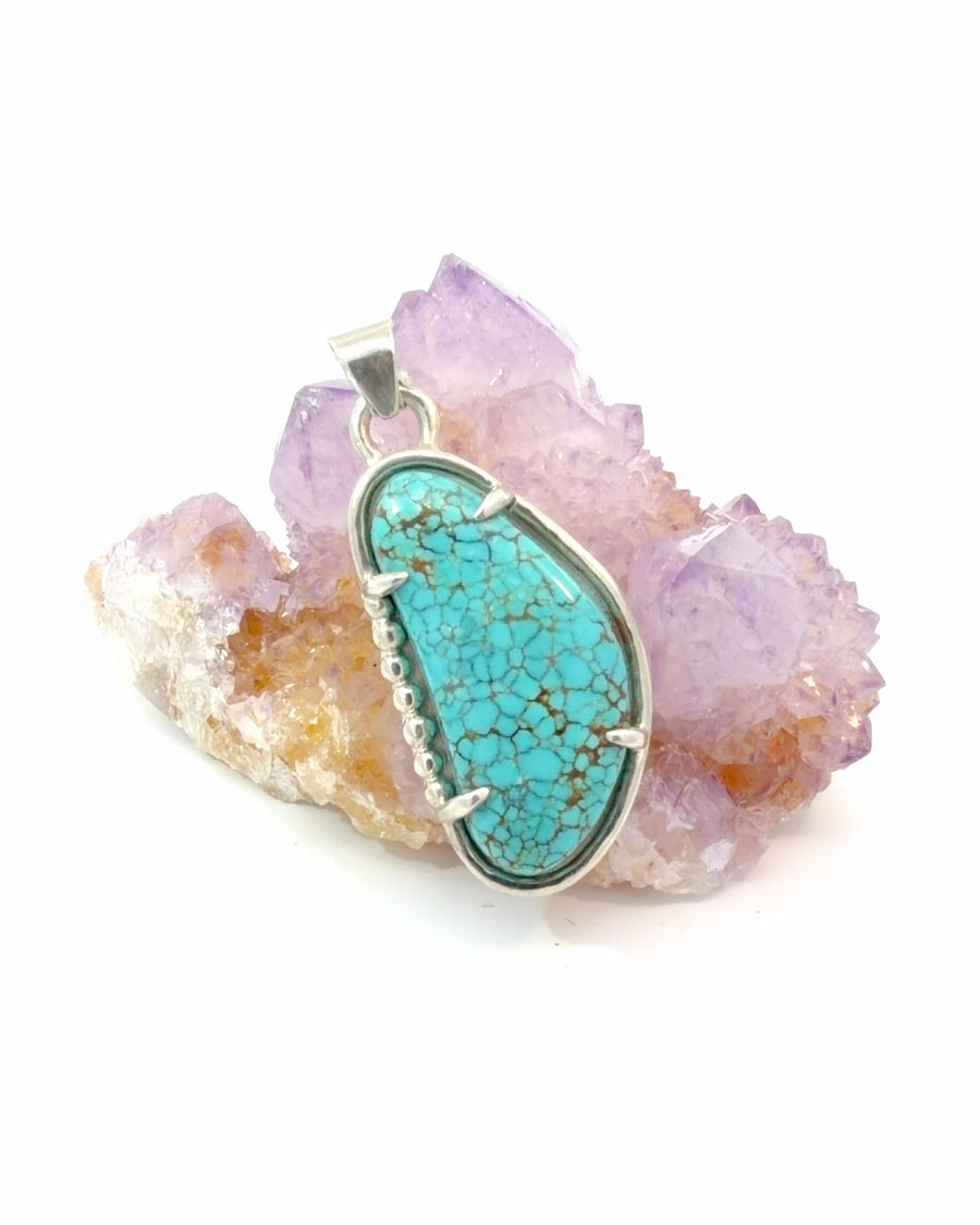 Freeform Spider-Web Turquoise cabochon pendant in sterling silver with decorative silver bead accents and natural blue spider-web matrix.