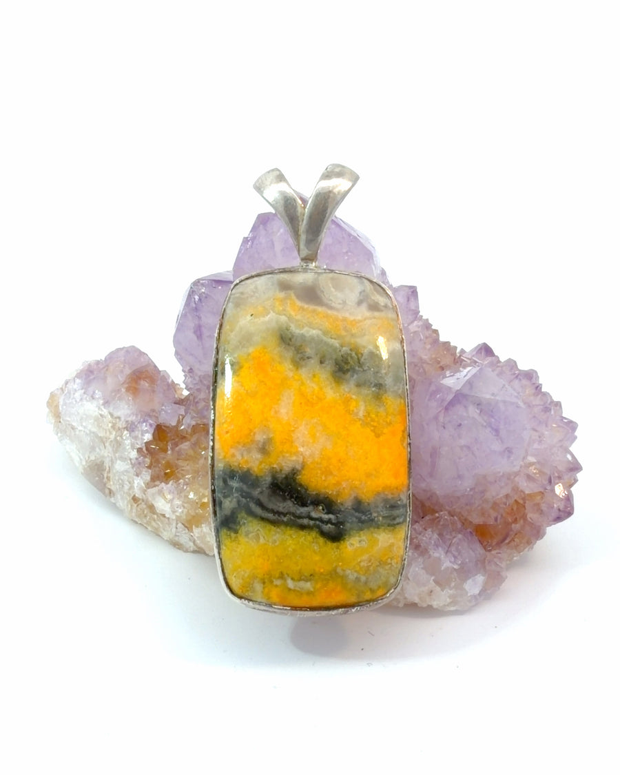 Natural Bumblebee Jasper pendant featuring yellow, black and grey banded gemstone in a sterling silver bezel setting.