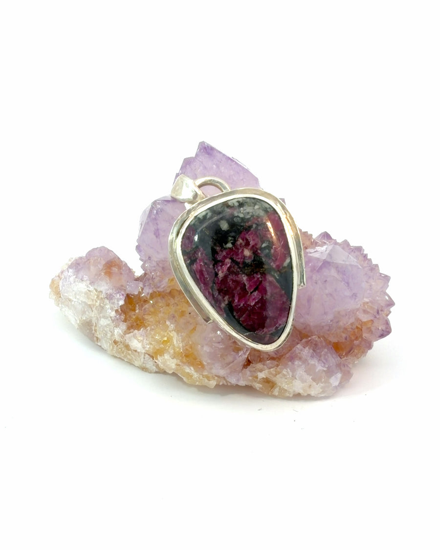 Natural Russian Eudialyte cabochon pendant set in sterling silver bezel with rich red and earthy mineral patterns.