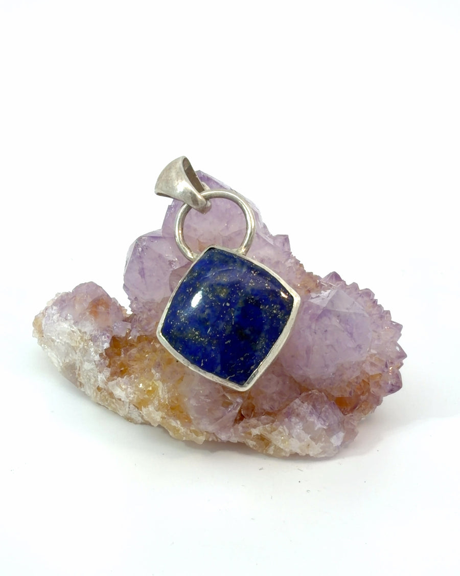 Square Lapis Lazuli pendant in sterling silver featuring deep royal blue color with natural golden pyrite flecks and a modern bezel setting.
