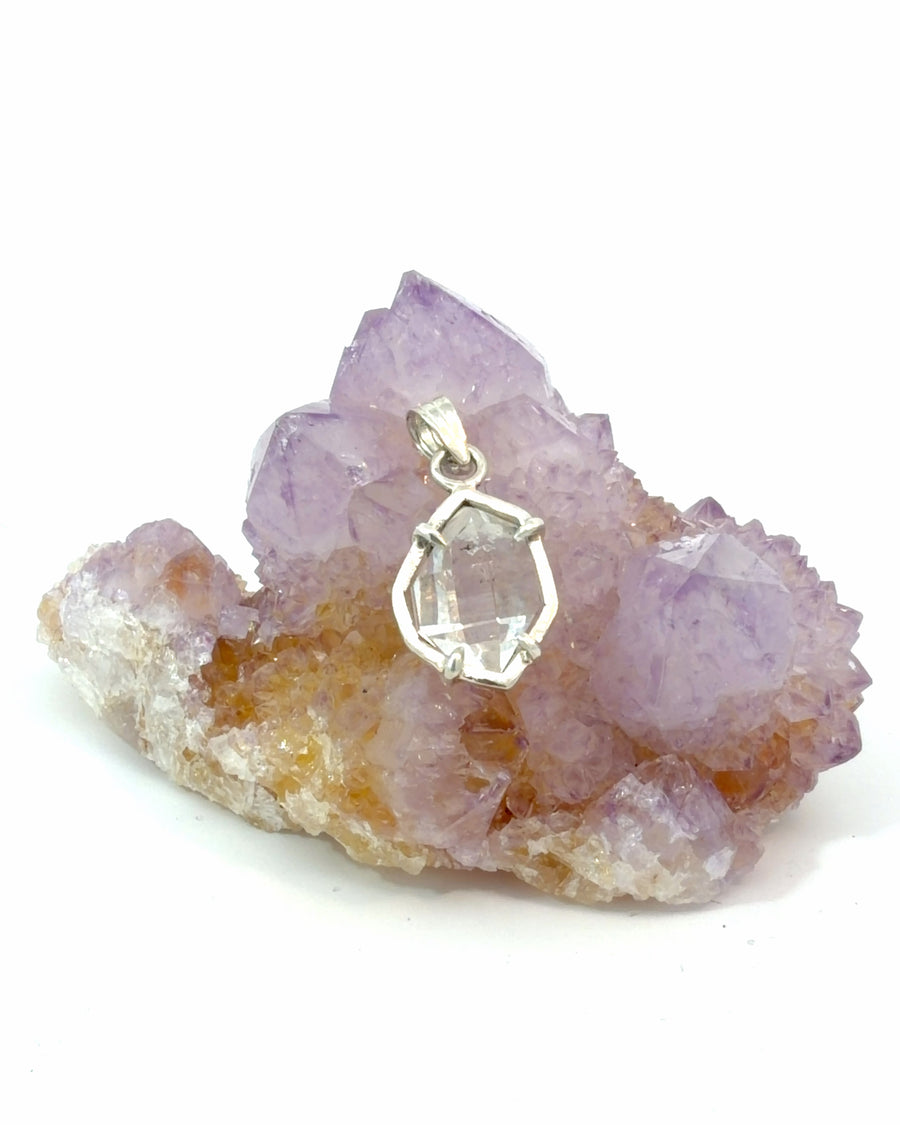 Natural Herkimer Diamond quartz crystal pendant in sterling silver featuring a clear, naturally faceted crystal in a minimalist handcrafted setting.