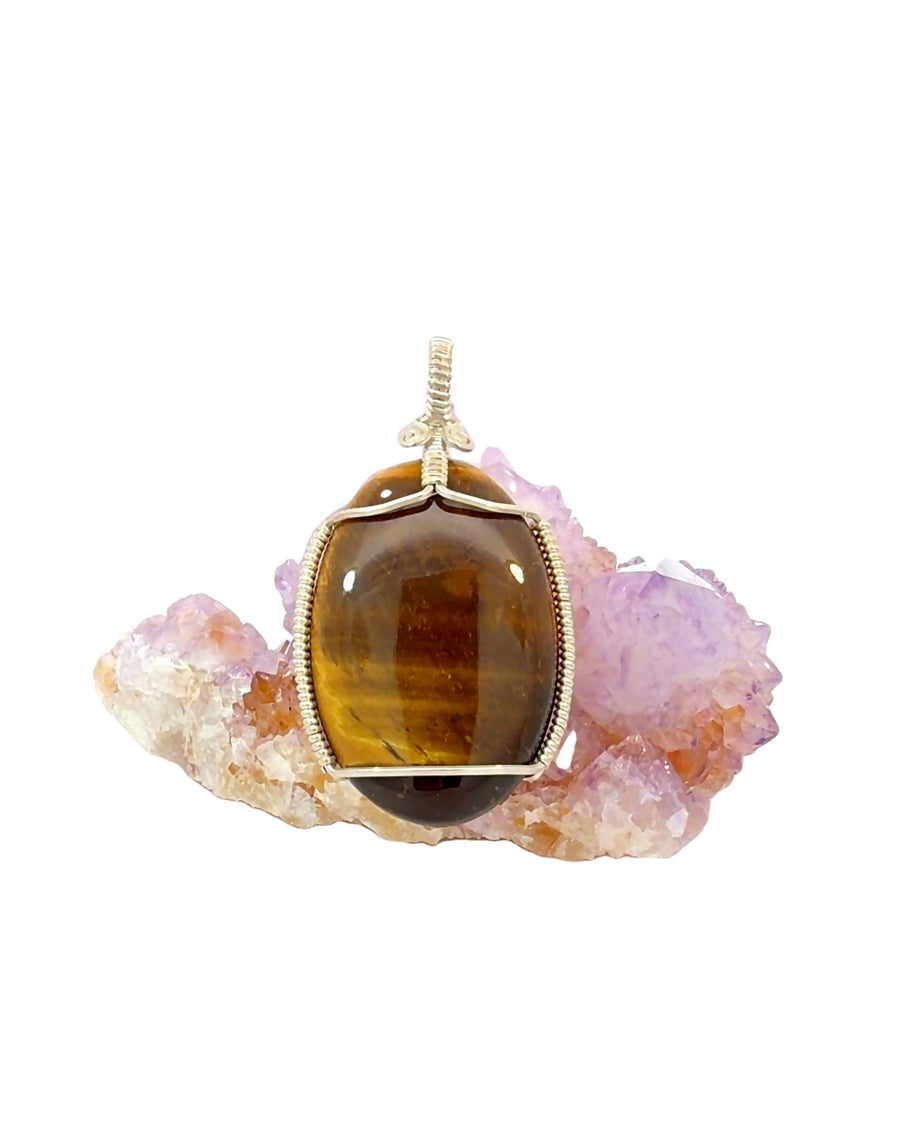 Golden brown Tiger’s Eye quartz oval cabochon pendant with chatoyant banding and handmade silver wire wrapping