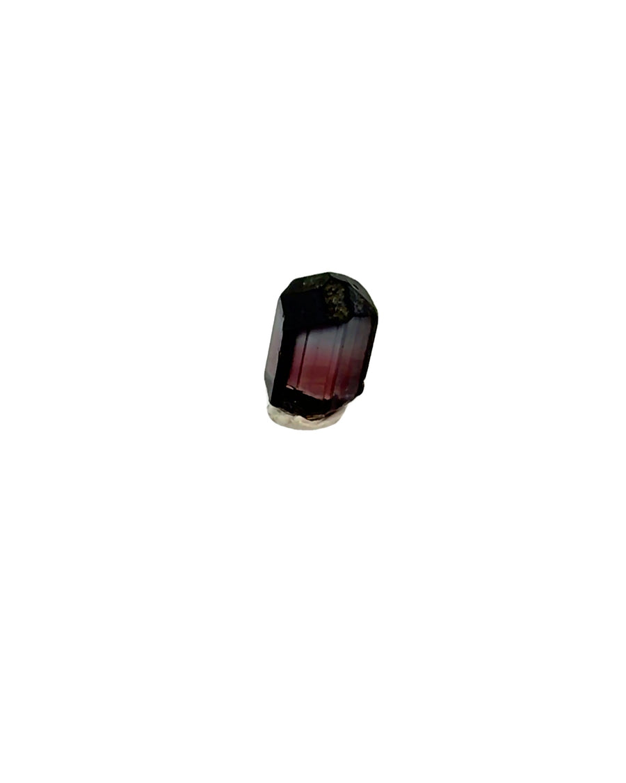 Natural raw bi-color blue and pink tourmaline crystal with prismatic shape, vertical striations, and color zoning, weighing 2.1 grams.