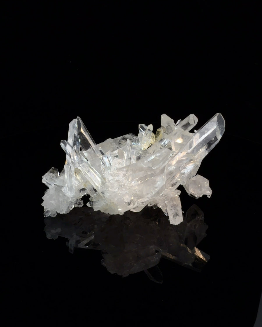Natural transparent crystal cluster with multiple clear prismatic points, unpolished mineral specimen measuring 6.9 x 5.4 x 3.5 cm
