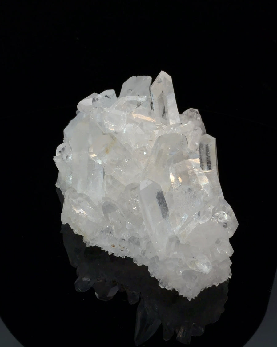Natural Arkansas quartz crystal cluster with transparent to translucent prismatic points and sharp faceted terminations, 11.6 cm