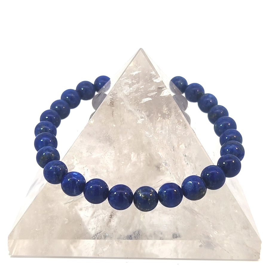 Natural Lapis Lazuli stretch bracelet featuring genuine deep blue gemstone beads with natural golden pyrite flecks on an elastic band.