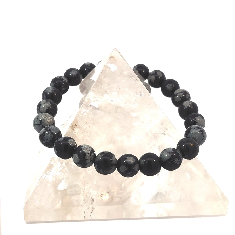 Natural Snowflake Obsidian stretch bracelet featuring distinctive black and grey snowflake patterns.