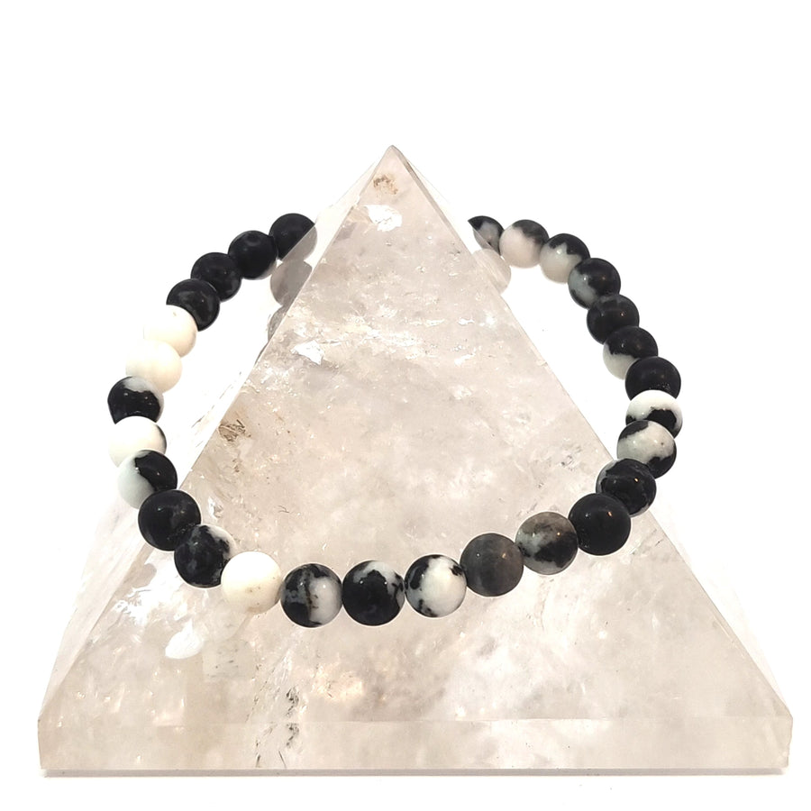 Natural Zebra Jasper stretch bracelet featuring polished black and white striped gemstone beads believed to encourage grounding, balance, courage, and inner strength.