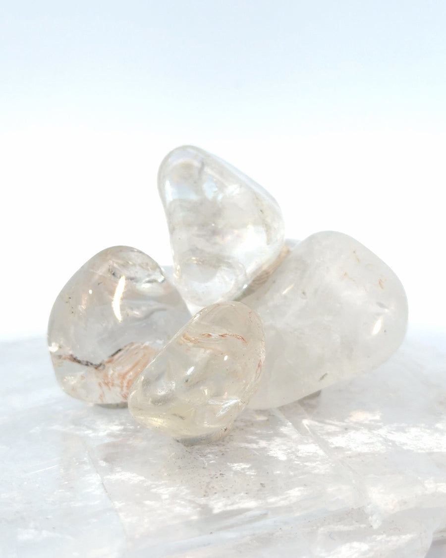 Set of 4 tumbled Clear Quartz stones with polished translucent natural crystal surfaces