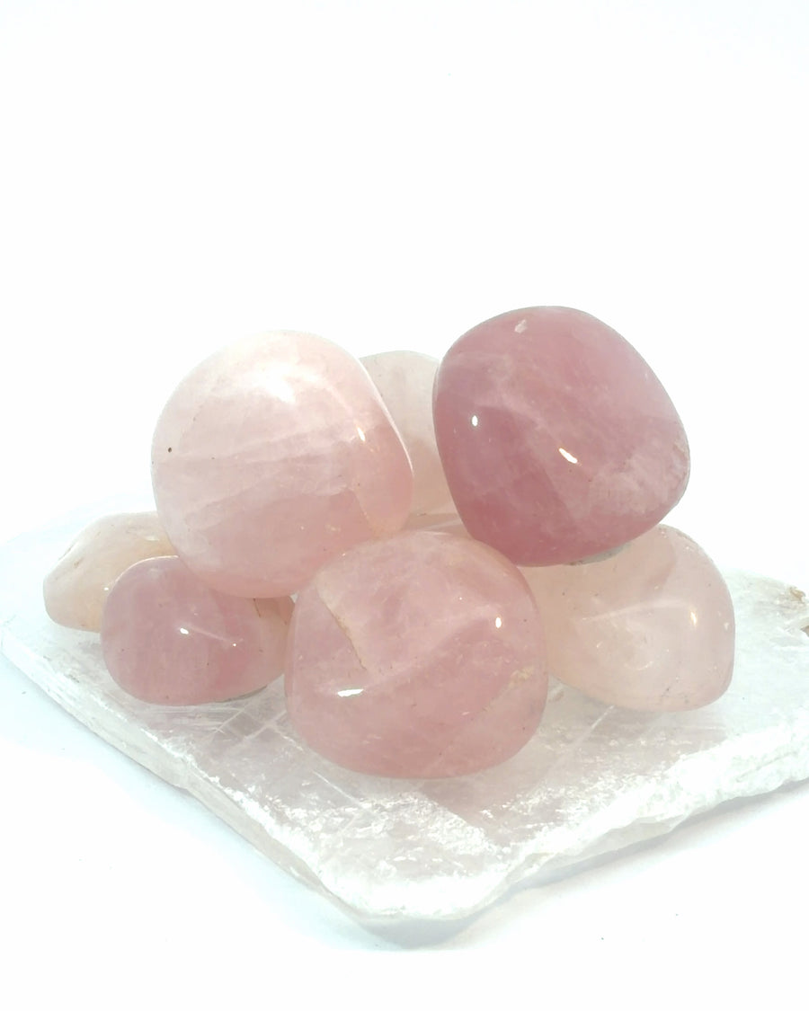 Set of 4 tumbled Rose Quartz stones with smooth polished pink crystal surfaces