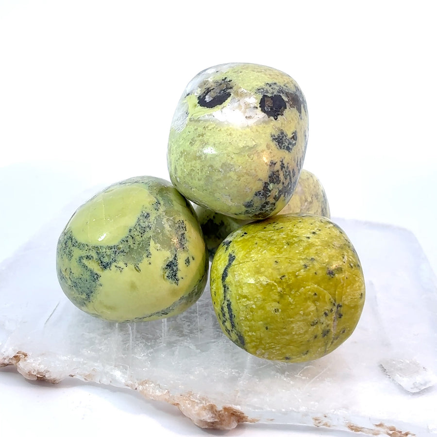 Set of 3 tumbled serpentine stones with polished green surfaces and natural mineral patterning