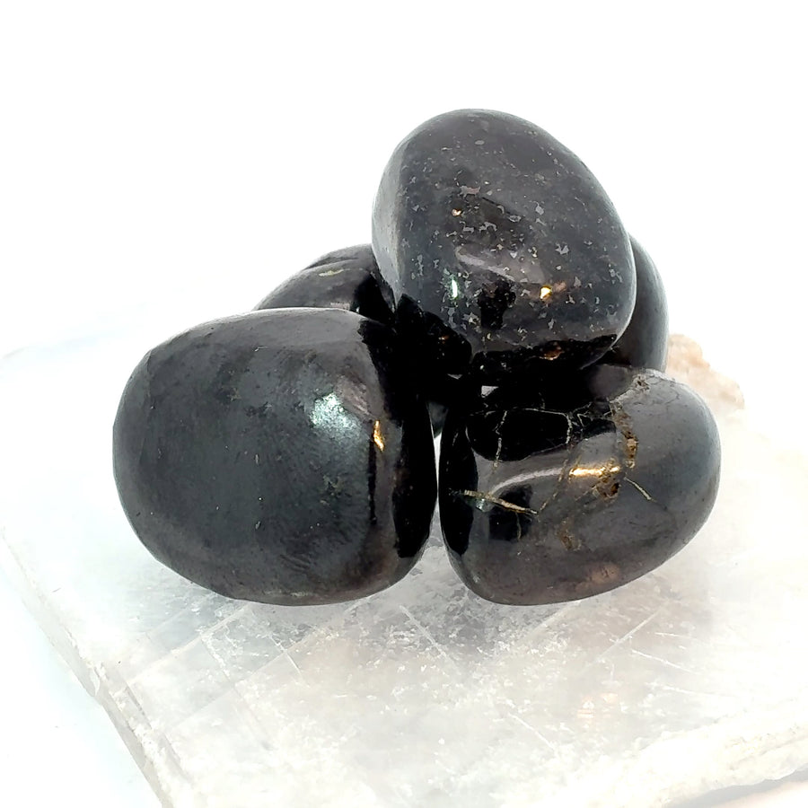 Set of 3 natural tumbled Shungite stones from Karelia, Russia with smooth polished black surfaces