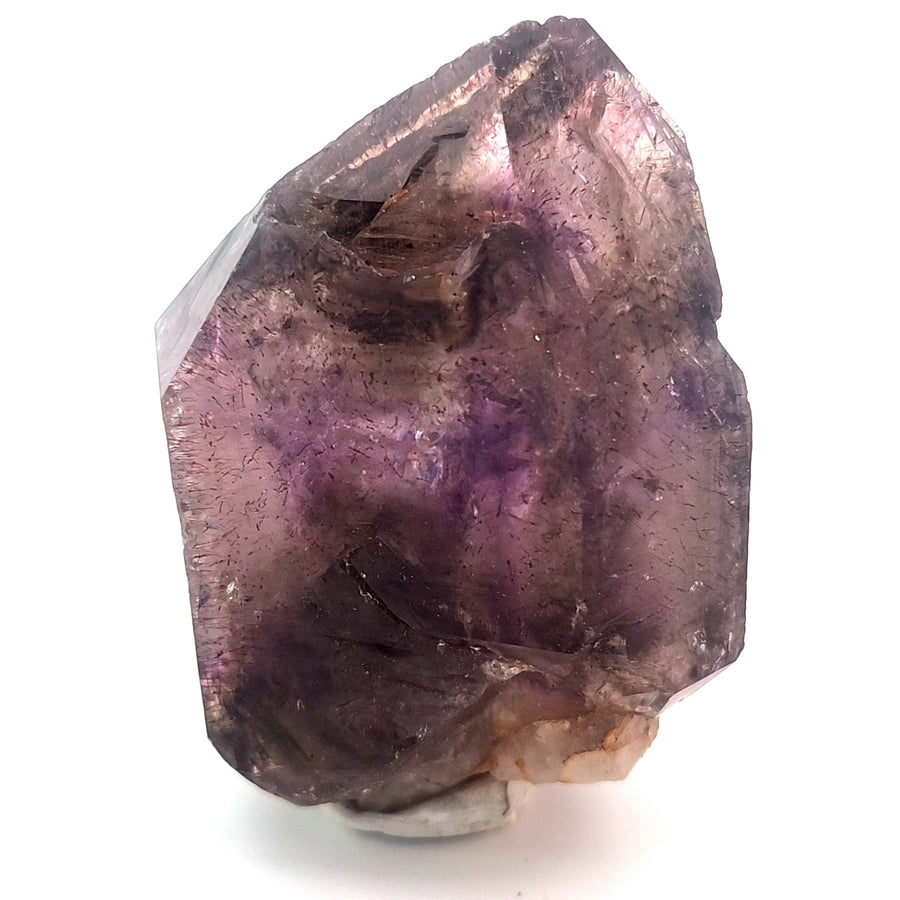 Natural amethyst scepter crystal from Chibuku Zimbabwe with smoky amethyst head, lighter scepter stem, hematite inclusions, and enhydros.
