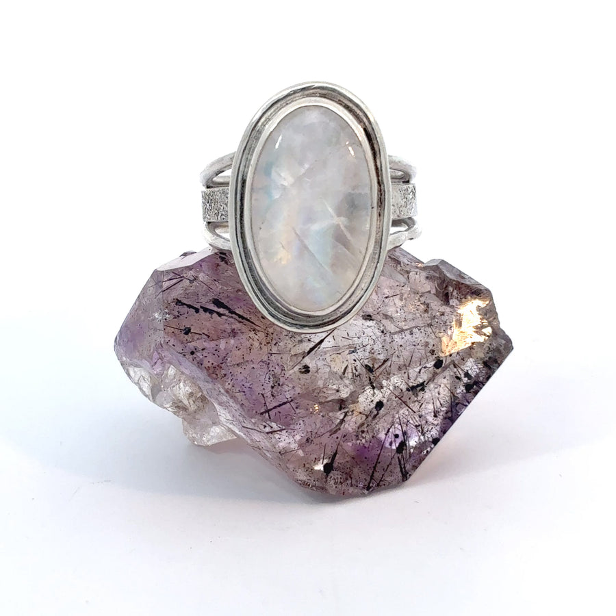 Natural moonstone ring with textured split band design, Size 7, displaying luminous adularescence and celestial elegance.