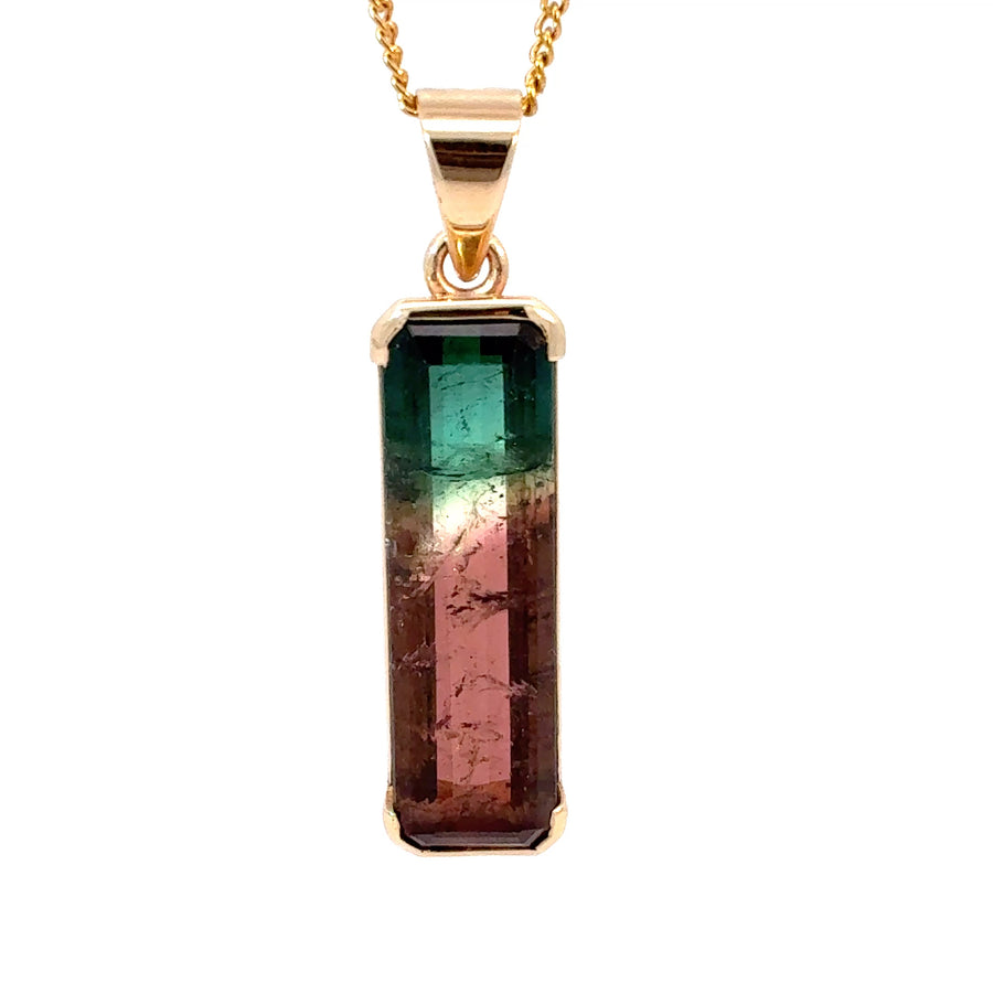 Discover a natural tri-color watermelon tourmaline featuring vibrant pink, green, and clear crystal zones, beautifully set in 18K gold. A unique collector-quality gemstone pendant measuring 38mm and weighing 6.4 grams.