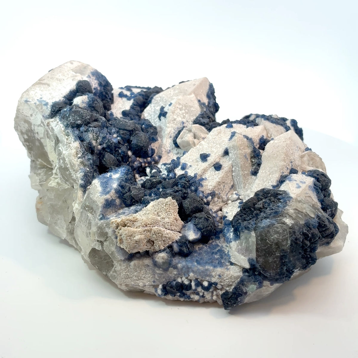 Natural blue fluorite crystals growing on white candle quartz from Inner Mongolia, collector-quality mineral specimen with vibrant blue crystal clusters.