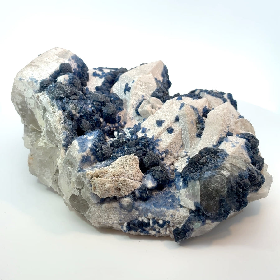 Natural blue fluorite crystals growing on white candle quartz from Inner Mongolia, collector-quality mineral specimen with vibrant blue crystal clusters.