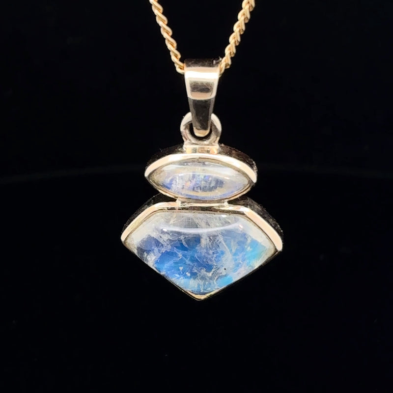 Natural moonstone two-stone pendant in polished 14K gold featuring luminous blue-white adularescence.