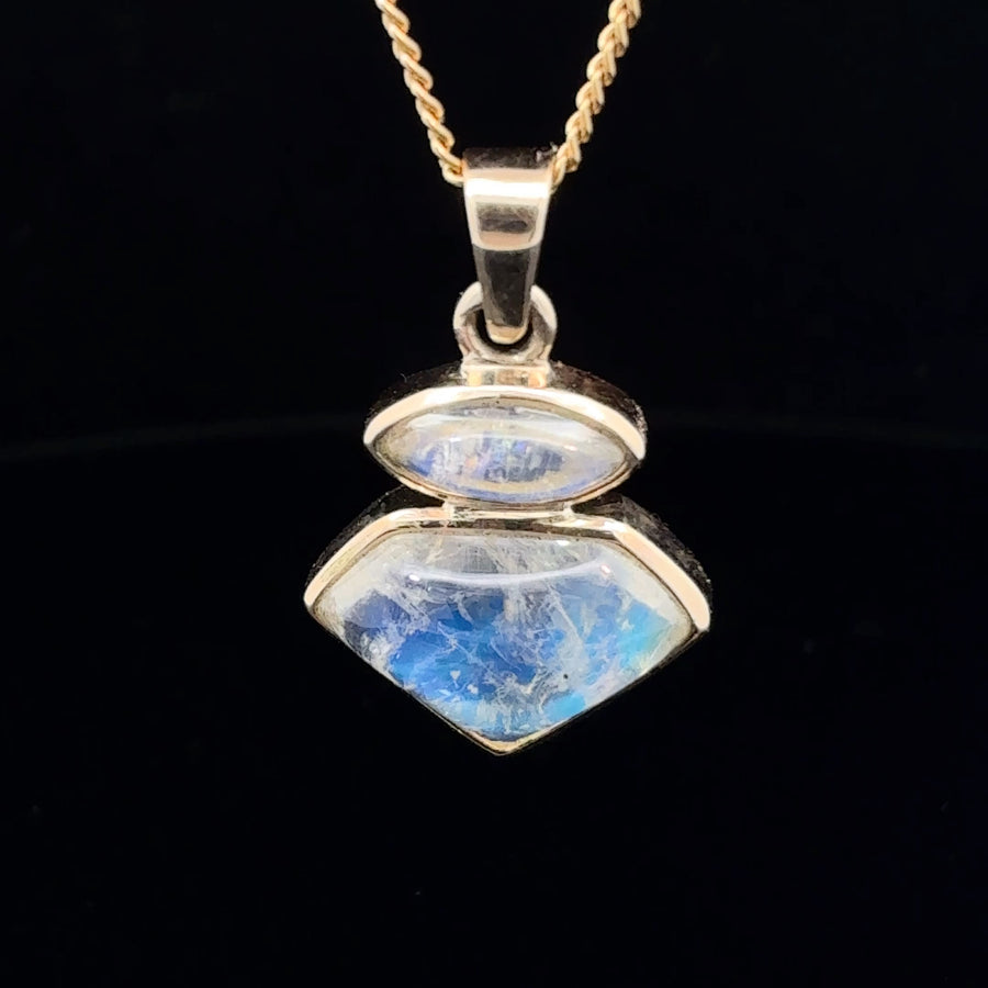 Natural moonstone two-stone pendant in polished 14K gold featuring luminous blue-white adularescence.