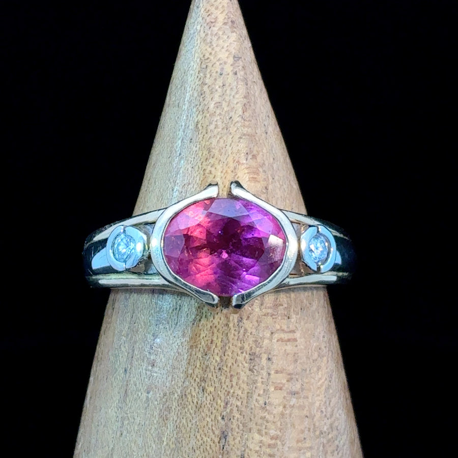 14K two-tone gold ring featuring a natural oval pink tourmaline with diamond accents in a split bezel setting. Size 7 statement ring.
