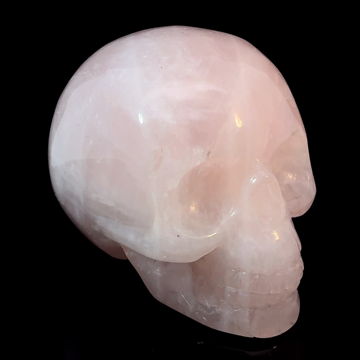Brazilian rose quartz carved crystal skull weighing 339 grams and measuring 76 x 47 x 60 mm