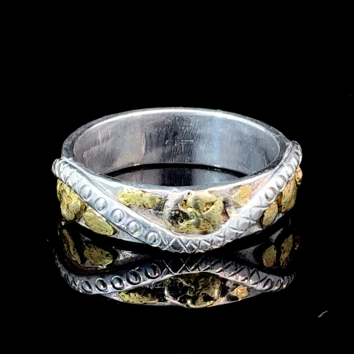 Handmade sterling silver ring with small natural Gold nuggets, hand-engraved details, and hammered band texture