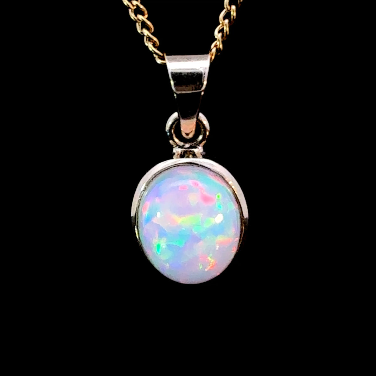 Oval Ethiopian Opal cabochon set in 14K Gold with natural play of color