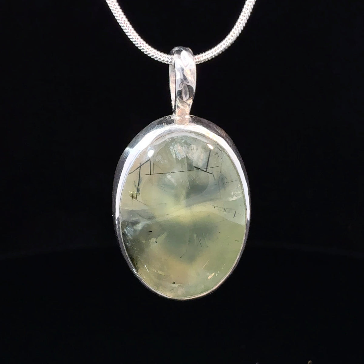 Oval Prehnite cabochon pendant in sterling silver with heart and flame cutout backplate, 35 x 19 mm
